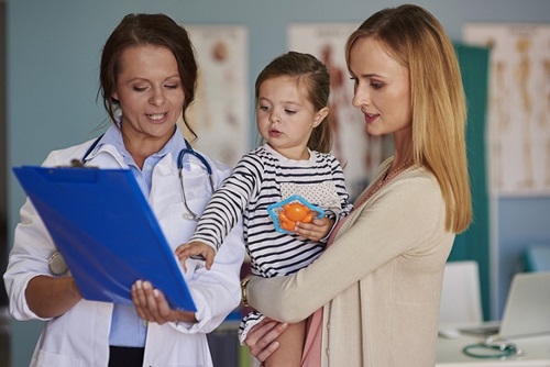 Mother, child and physician i the  Emergency Room.